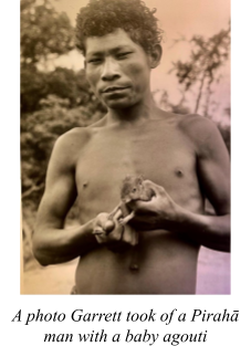 Pirahā man holding baby agouti